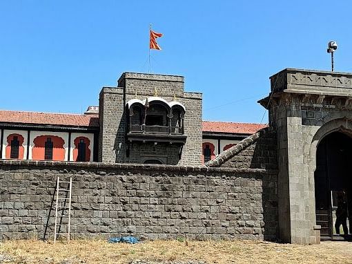 A large, stone building with a tower and a flag flying from it. The building appears to be a replica of a historical fort or palace.